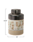 The Creative Co-op Ginger Jar is a hand-painted stoneware piece with a lid, featuring brown, beige, and white floral motifs. It measures 13.25" tall by 8.5" wide.