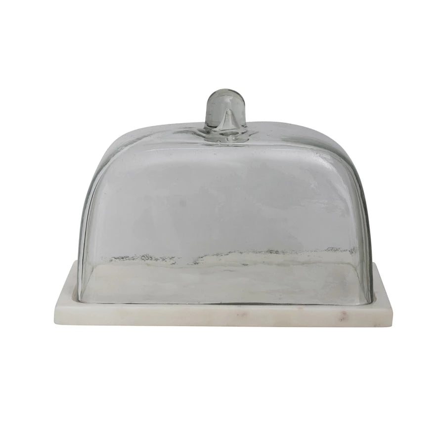 The Creative Co-op Glass Cloche White Marble L features a clear glass dome with knob handle on a rectangular white marble base, offering stylish farmhouse-inspired storage for cheese, butter, or kitchen essentials.