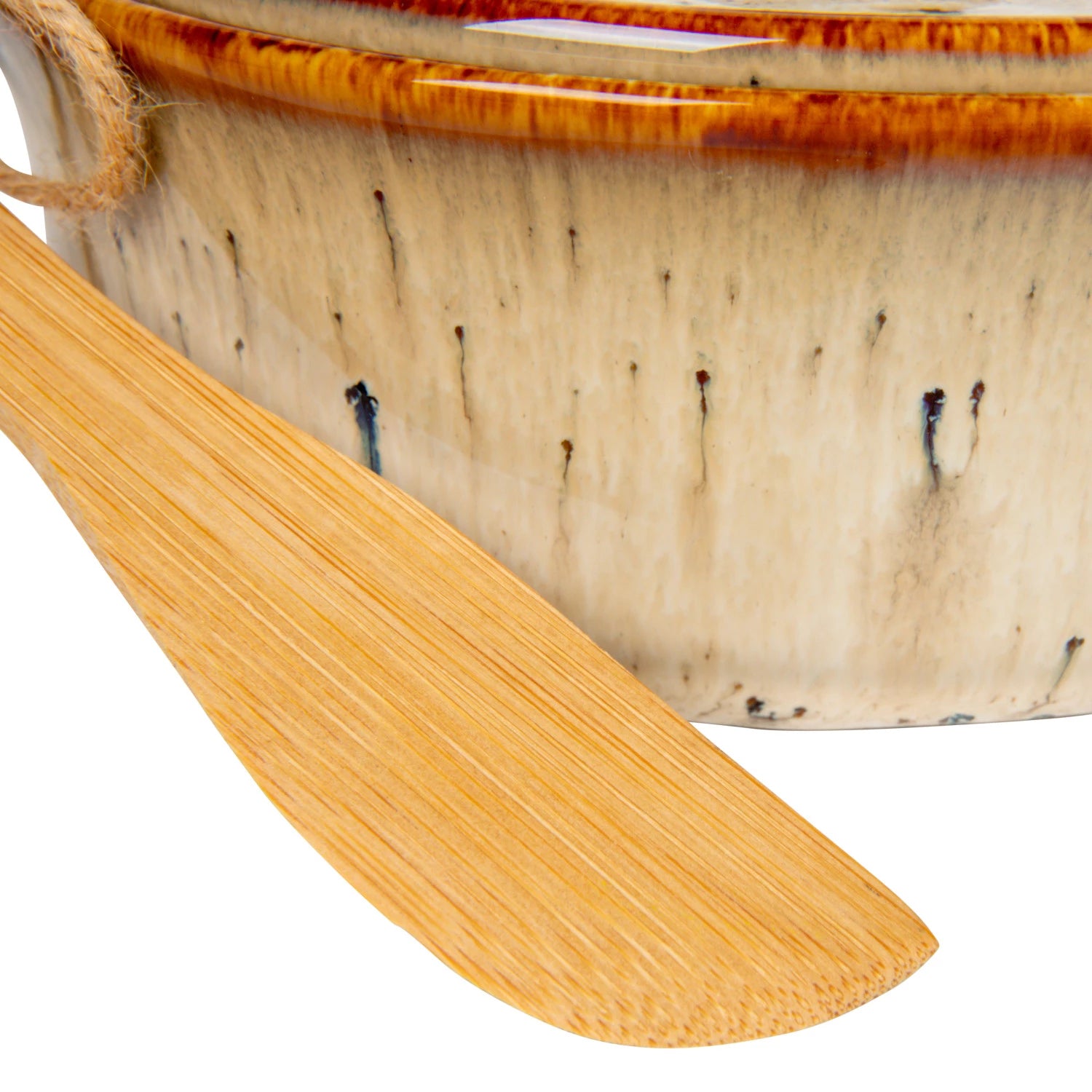 A close-up of the Creative Co-op Brie Baker with Bamboo Spreader, featuring a brown-glazed, speckled ceramic bowl—perfect for serving with any farmhouse-style canapé knives or as a charming addition to your bakeware.