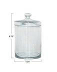 The Creative Co-op DF9421 Glass Jar w/ Lid features a knob handle, measures 8.75" tall by 5.25" in diameter, and is perfect for kitchen storage or decor—shown on a plain white background with measurement lines.