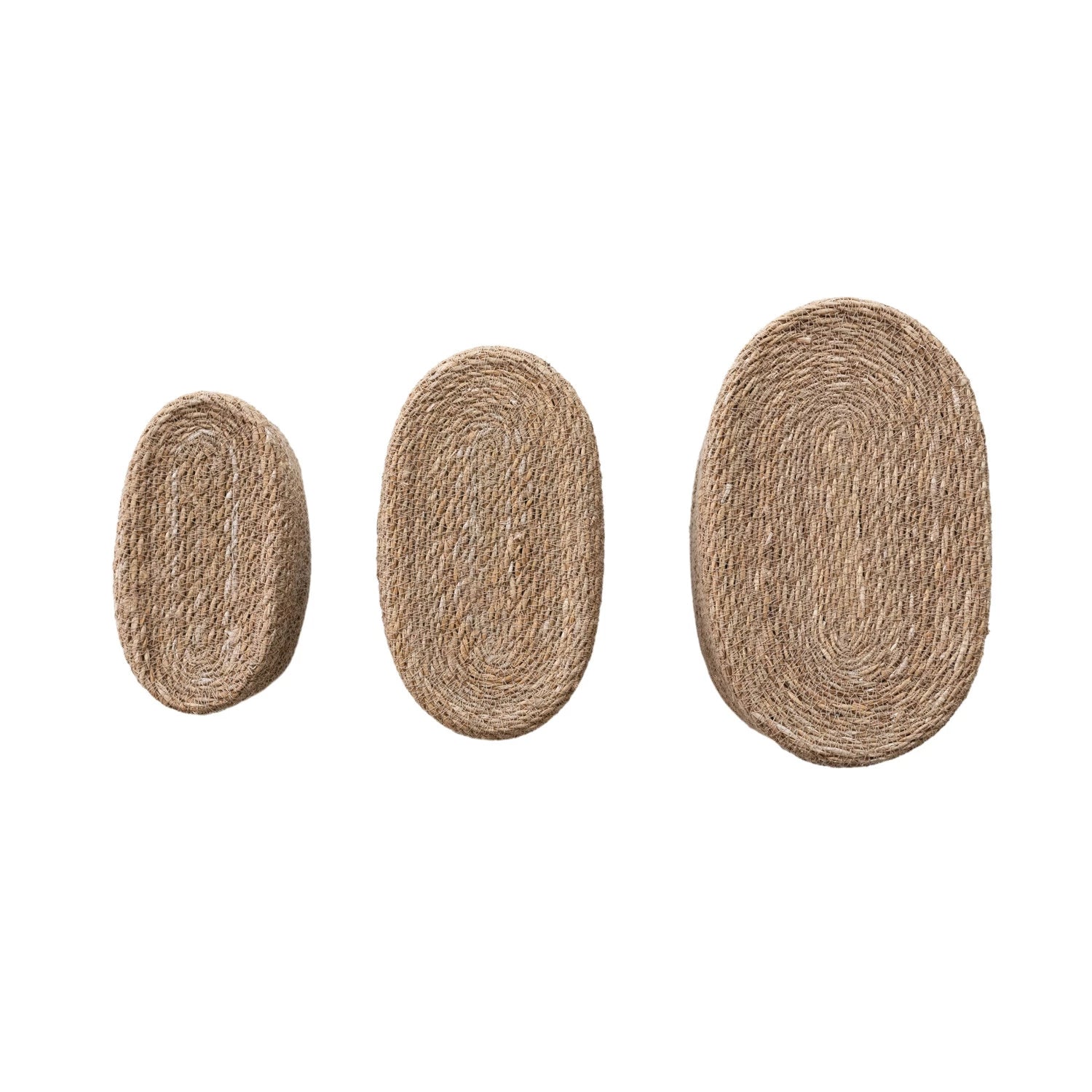 Three Creative Co-op Sea Grass Baskets (Long Oval) of different sizes are arranged in a row on a white background, smallest to largest, perfect for organizing household items.