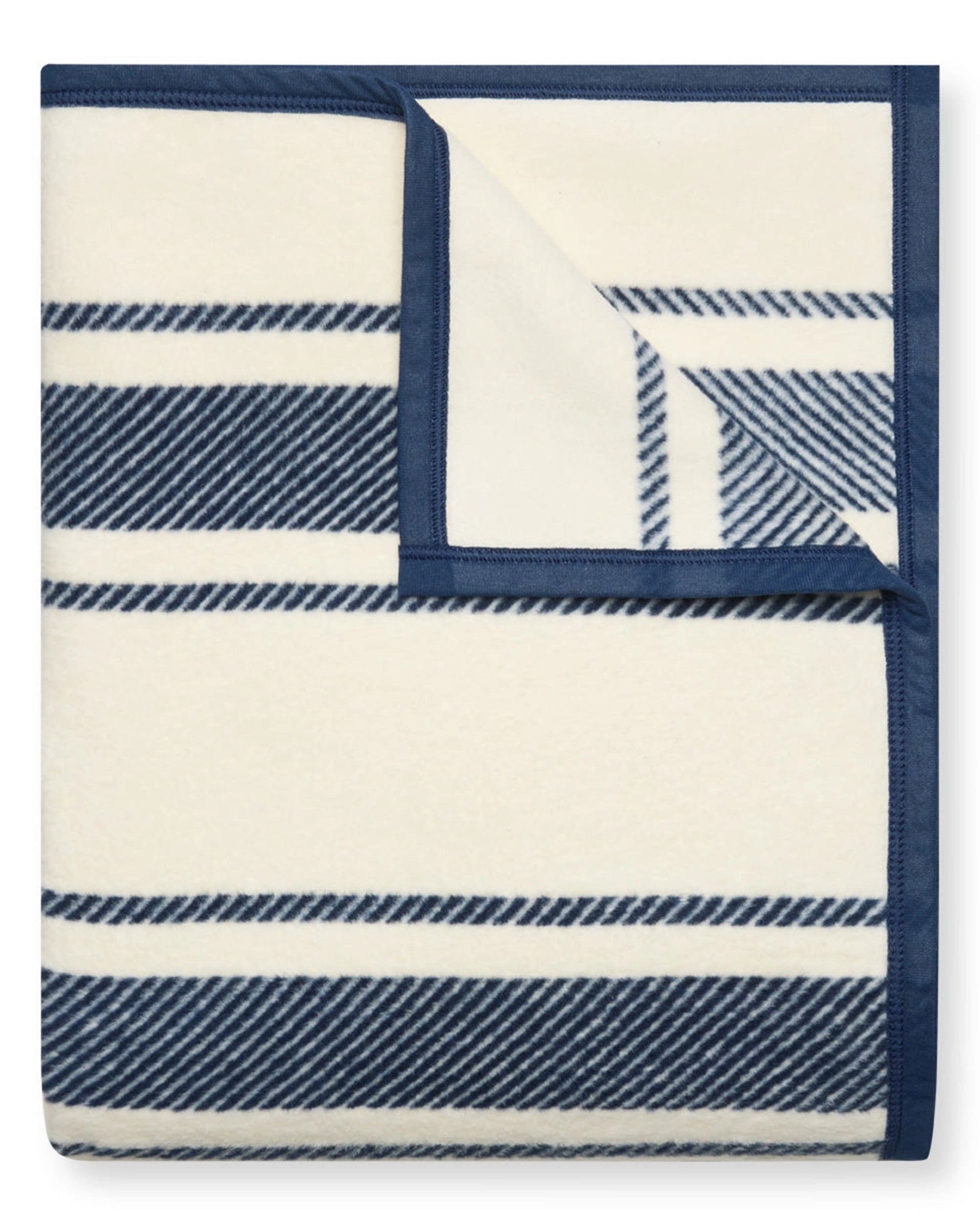 The Dockside Stripe Blanket by Faire features blue and white stripes, perfect for bringing a nautical touch to your space.