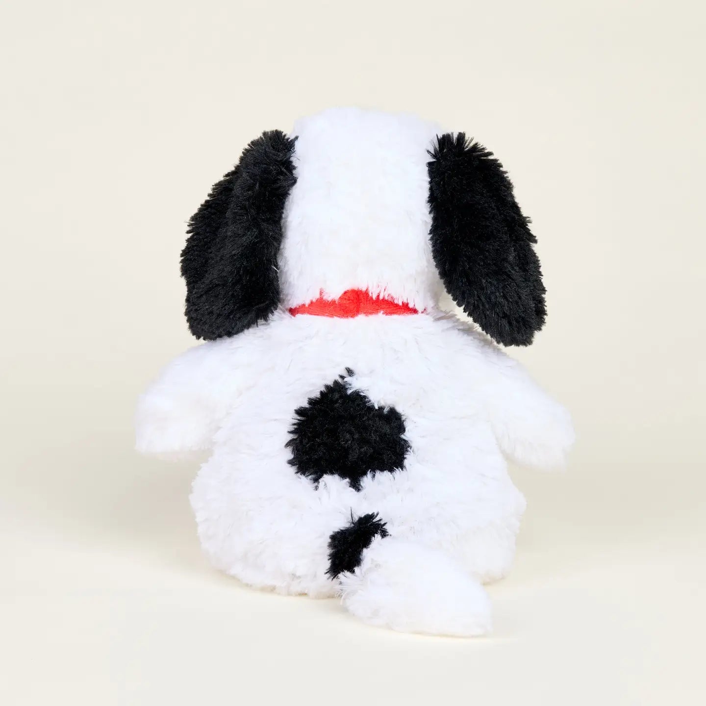 The Warmies/Intelex Snoopy / Red Collar Warmies is a microwavable plush dog with white fur, black ears, a red collar, and black spots, shown from the back on a plain light background for enhanced sensory comfort.