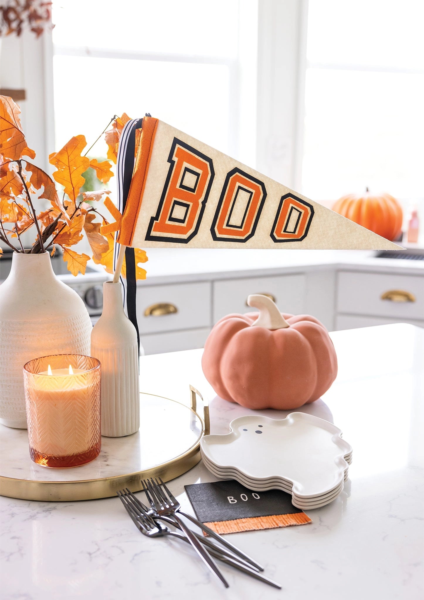 Cozy kitchen with Faire Boo felt pennant banner and autumn Halloween decor from Bungalow Furniture &amp; Accessories.