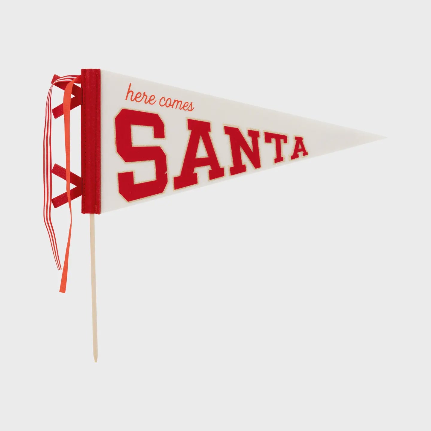 The Santa Felt Pennant Flag by Faire features bold red letters spelling "Here Comes Santa," perfect for adding charm to your holiday décor. With red ribbon accents along the left side, it's a delightful addition to any seasonal celebration.