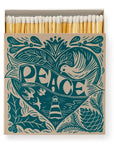 A fun box of Faire's Square Matches displays "PEACE" in teal on the cover, featuring a dove, leaves, pinecones, and a lighthouse for harmony. The open matchbox shows matchsticks ready for use.