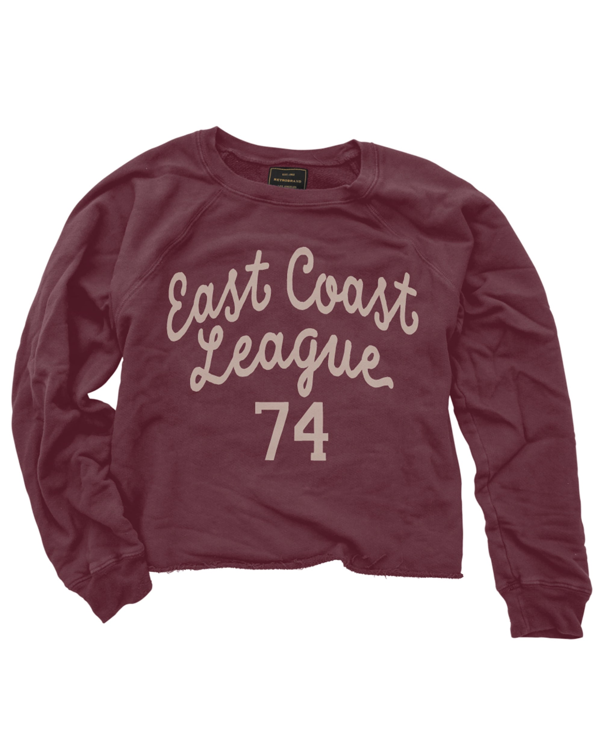The Wildcat Retro Brands "East Coast League 74" vintage maroon cropped sweatshirt features white cursive text, soft French terry fabric, and an unfinished hem for a laid-back vibe. Made in the USA.