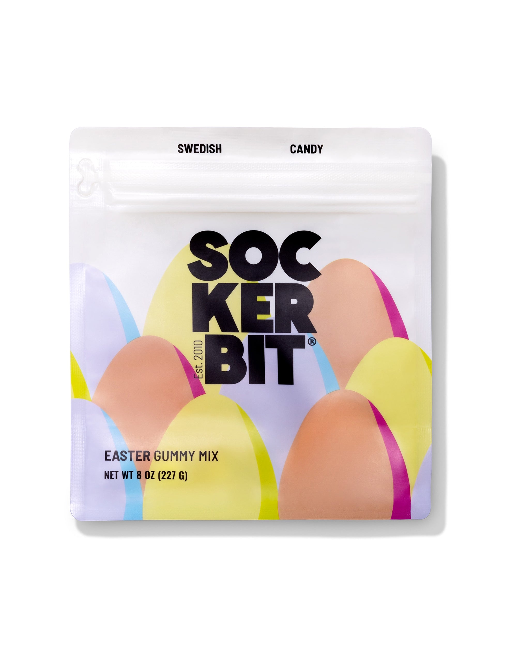 A white resealable bag labeled "Easter Gummy Mix" by Faire contains a sweet and sour spring candy assortment. The pastel package reads "Swedish Candy," "Net Wt 8 oz (227 g)," and the gummies are made in Sweden.