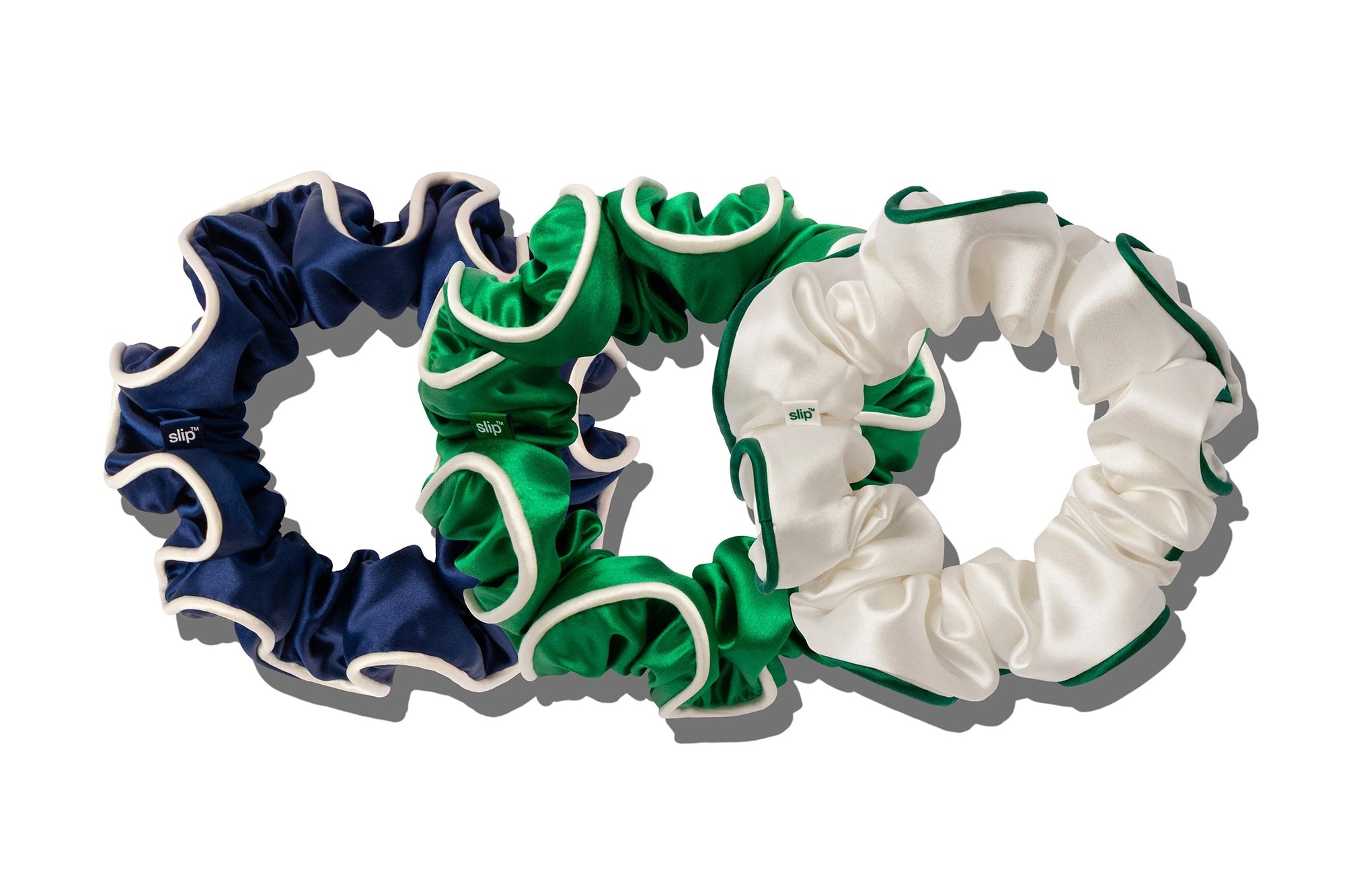 Three Faire Game Day Large Scrunchies are displayed side by side on a white background in navy blue, green, and white with green trim.