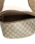 A black leather Faire Britt Belt Bag featuring a sleek design and adjustable strap, shown open to reveal its spacious interior—a timeless designer accessory for any collection.