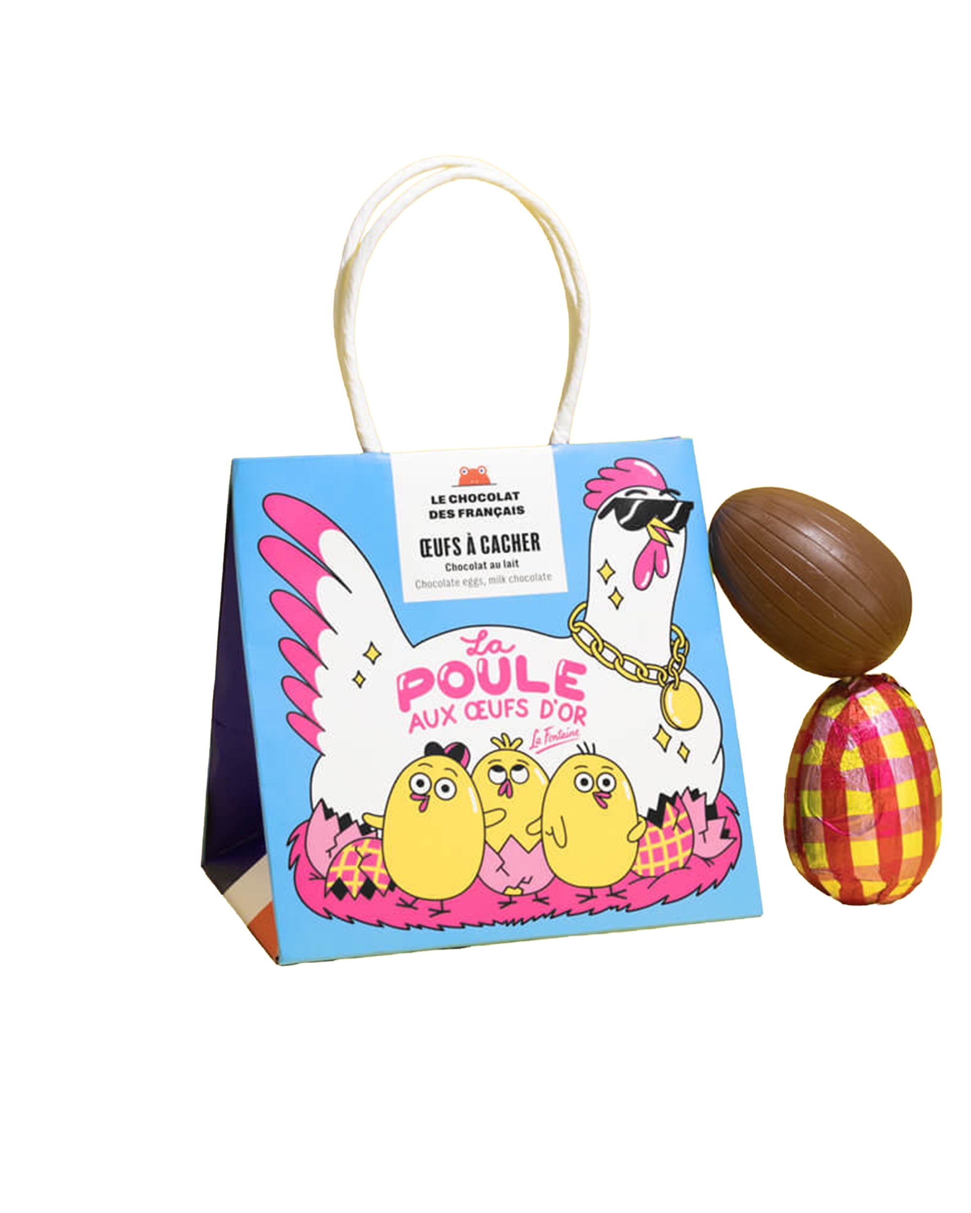 The Egg Bag by Les Chocolat Des Francais features a vibrant cartoon hen with sunglasses and gold jewelry, surrounded by three chicks. Next to the bag are two Easter chocolate eggs, one wrapped in shiny foil.