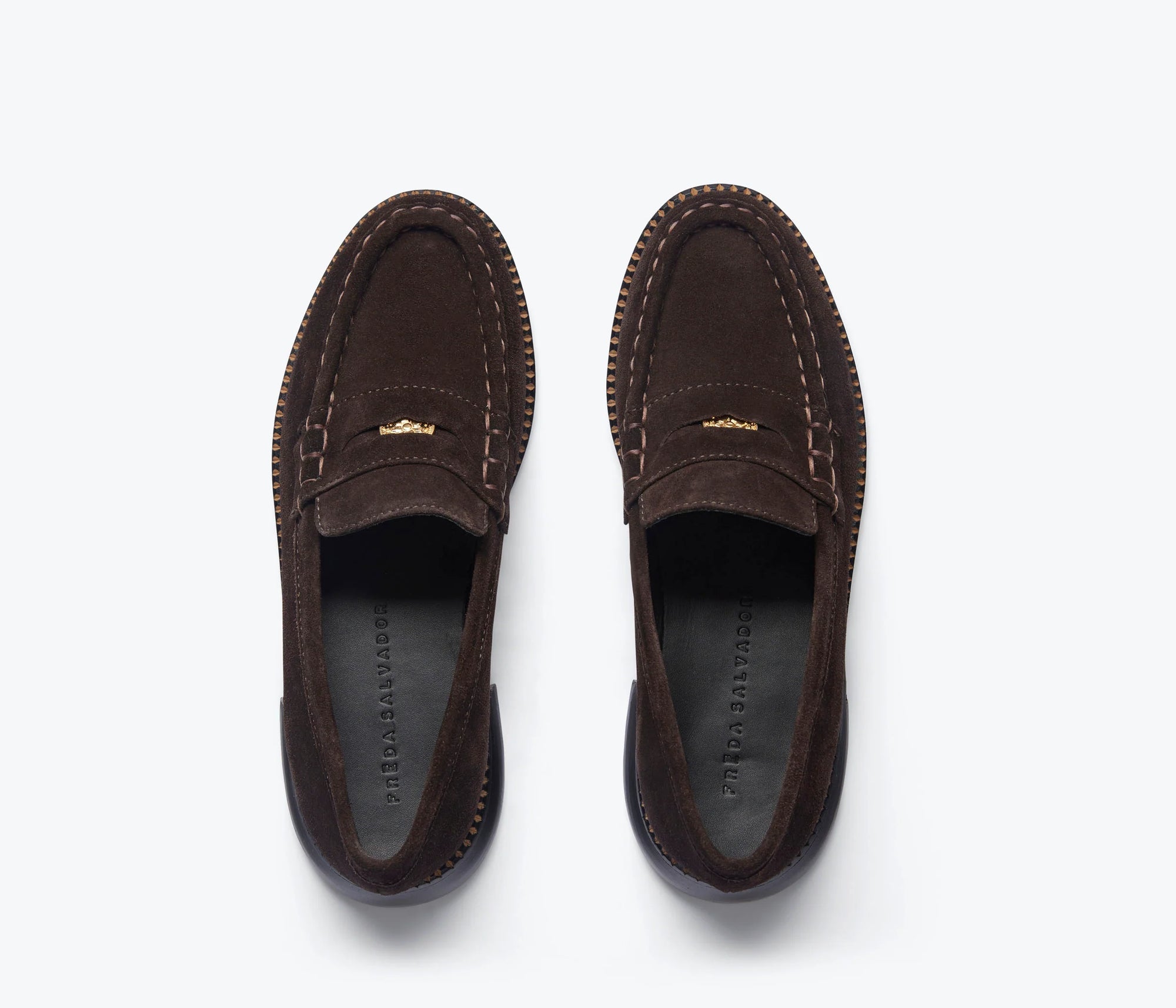 The Freda Salvador Elba Espresso Suede Loafer features visible edge stitching and gold front detailing, shown from above on a light gray background.
