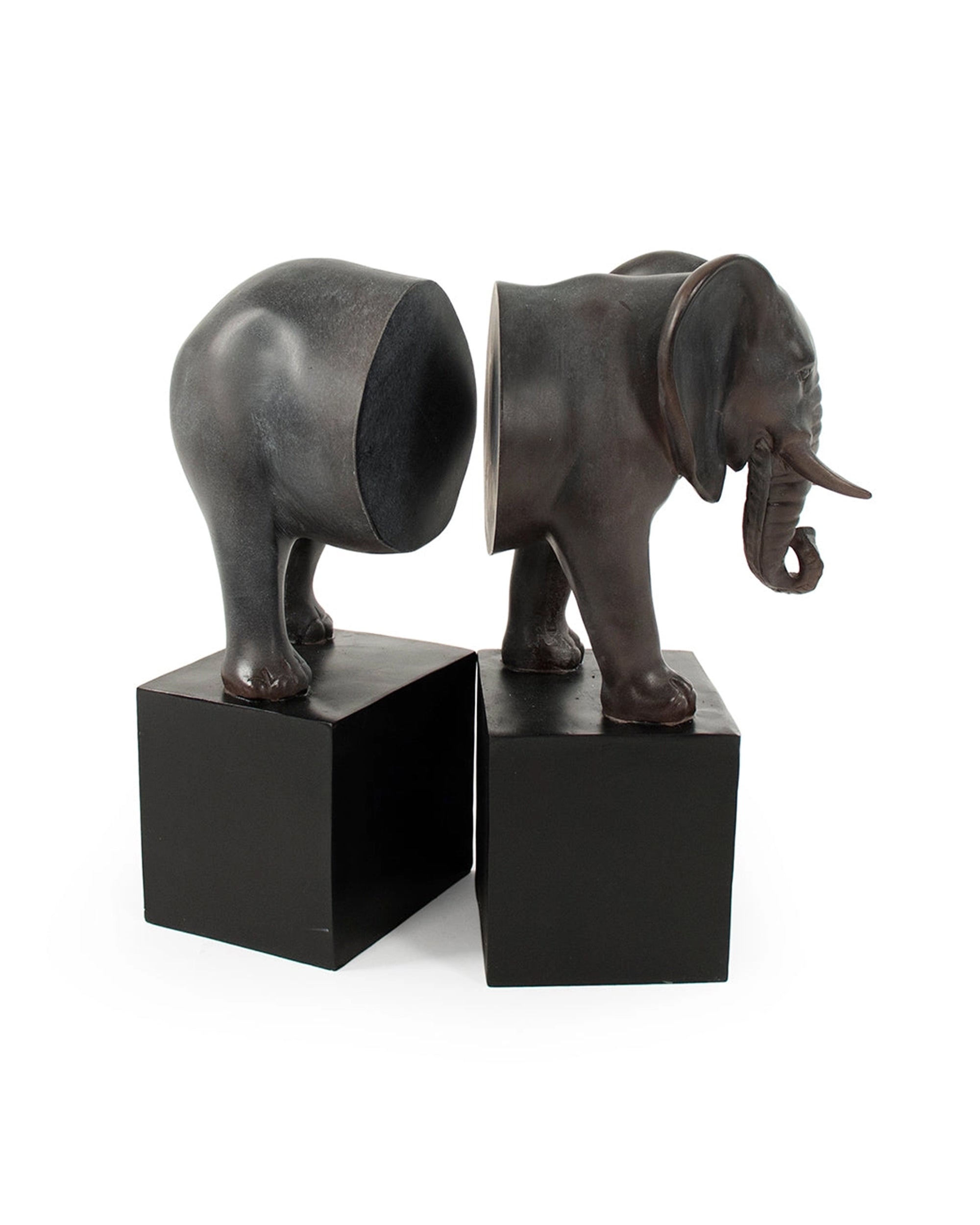 The Zentique Elephant Bookends feature an elephant split in half, with each section on a black rectangular base, facing each other to create a unique and decorative touch for any bookshelf.