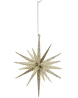 The Faire Christmas Ornaments Assorted features a gold glittery starburst with long, pointed rays, hanging from a silver string—perfect for holiday decorating.