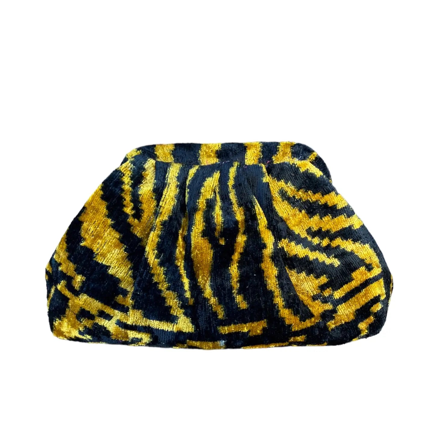 The Faire Silk Velvet Ikat Soft Clutch features a bold black and gold abstract zigzag pattern with textured, hand-woven artisanal details.