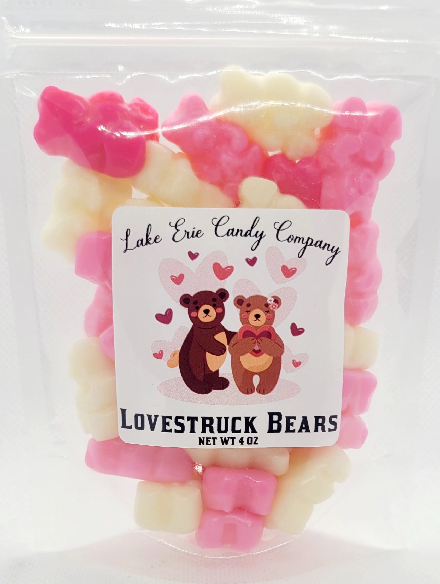 A clear bag labeled "Lake Erie Valentine Candy" from Faire holds a charming assortment of pink, white, and red gummy bears—perfect Valentine sweets to share. The bag features cute bear cartoons surrounded by hearts.