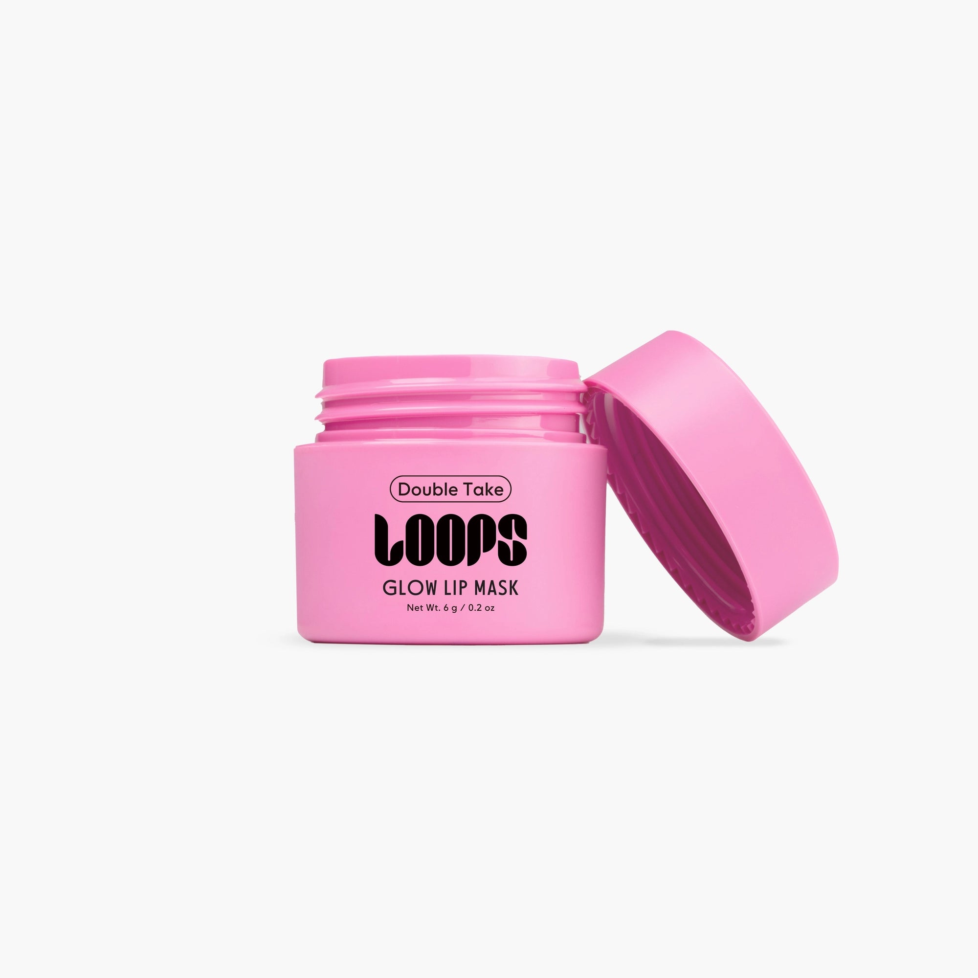 An open pink jar of Faire’s LOOPS Glow Lip Mask sits against a white background—ideal for nourishing your lips.