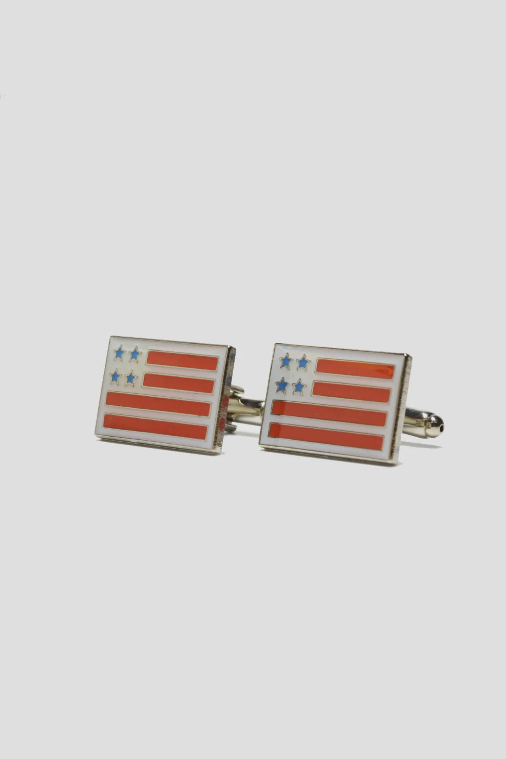 A pair of Curated Basics MENS Cufflinks designed in silver-plate, showcasing a rectangular shape with an American flag motif, consisting of red stripes and blue stars on a white enamel background.