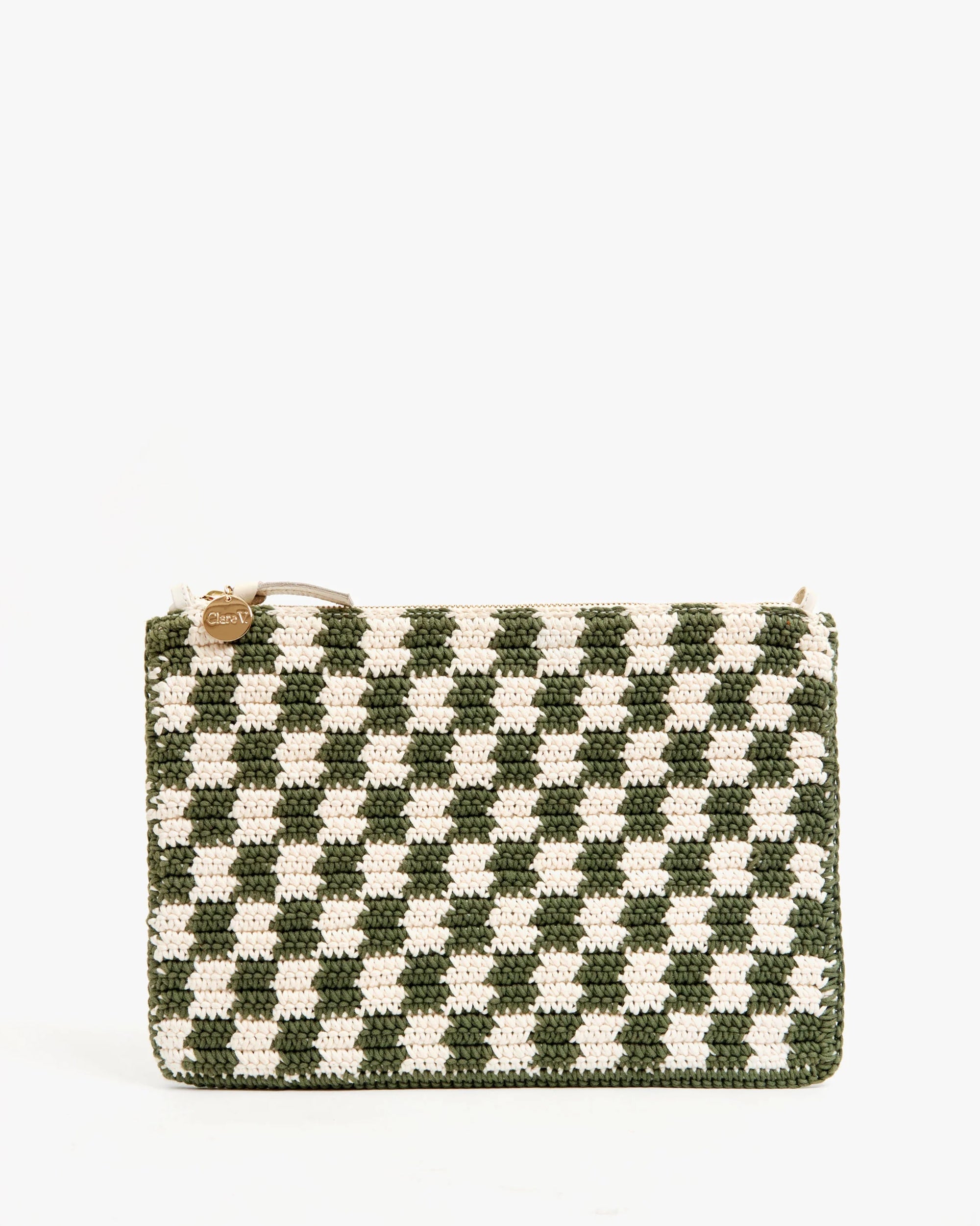 The Clare Vivier Flat Clutch W/Tabs is a rectangular crocheted cotton bag in green and white checkerboard, accented with a small gold round charm on the zipper. Set against a plain white background.