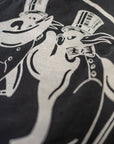 The Fleetwood Mac Tee by Made Worn features a black and white illustration of a bear and rabbit in top hats and tuxedos, dancing joyfully. This vintage unisex tee is made in the USA from 100% cotton for comfort and timeless appeal.