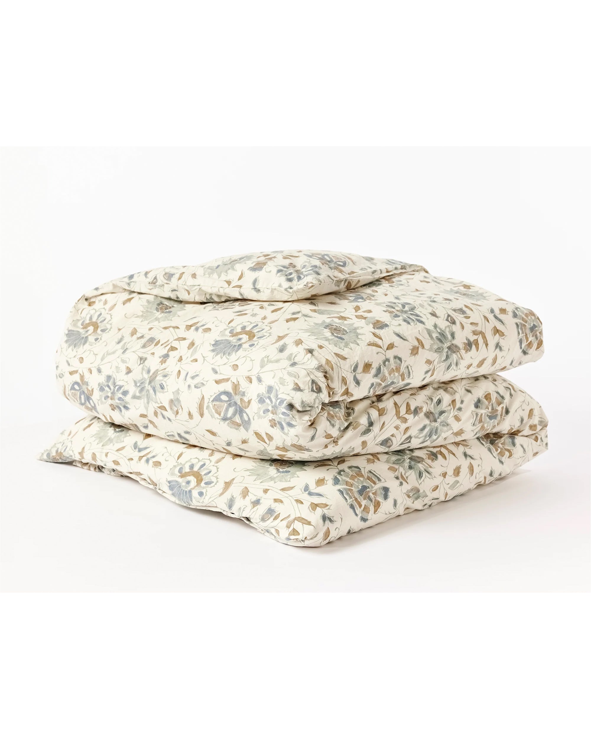 The Coyuchi Inc Flora Org Print Duvet Undyed Lagoon King/CKing showcases a woodblock-style floral pattern in soft blue, green, and beige on white, elegantly folded and displayed against a plain white surface.