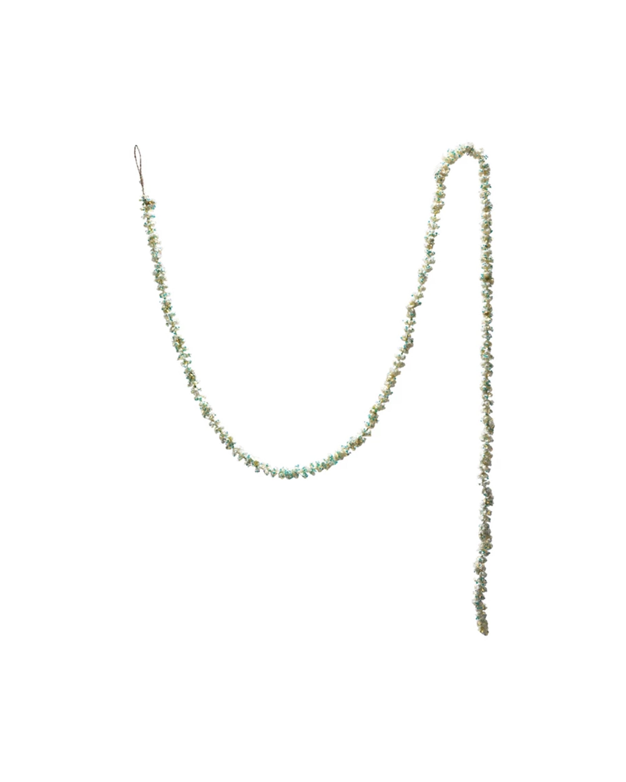 The Creative Co-op Foam Glitter Garland features small pale green and white flowers with subtle iridescent glitter, arranged in a single strand with a loop at one end, displayed against a white background.