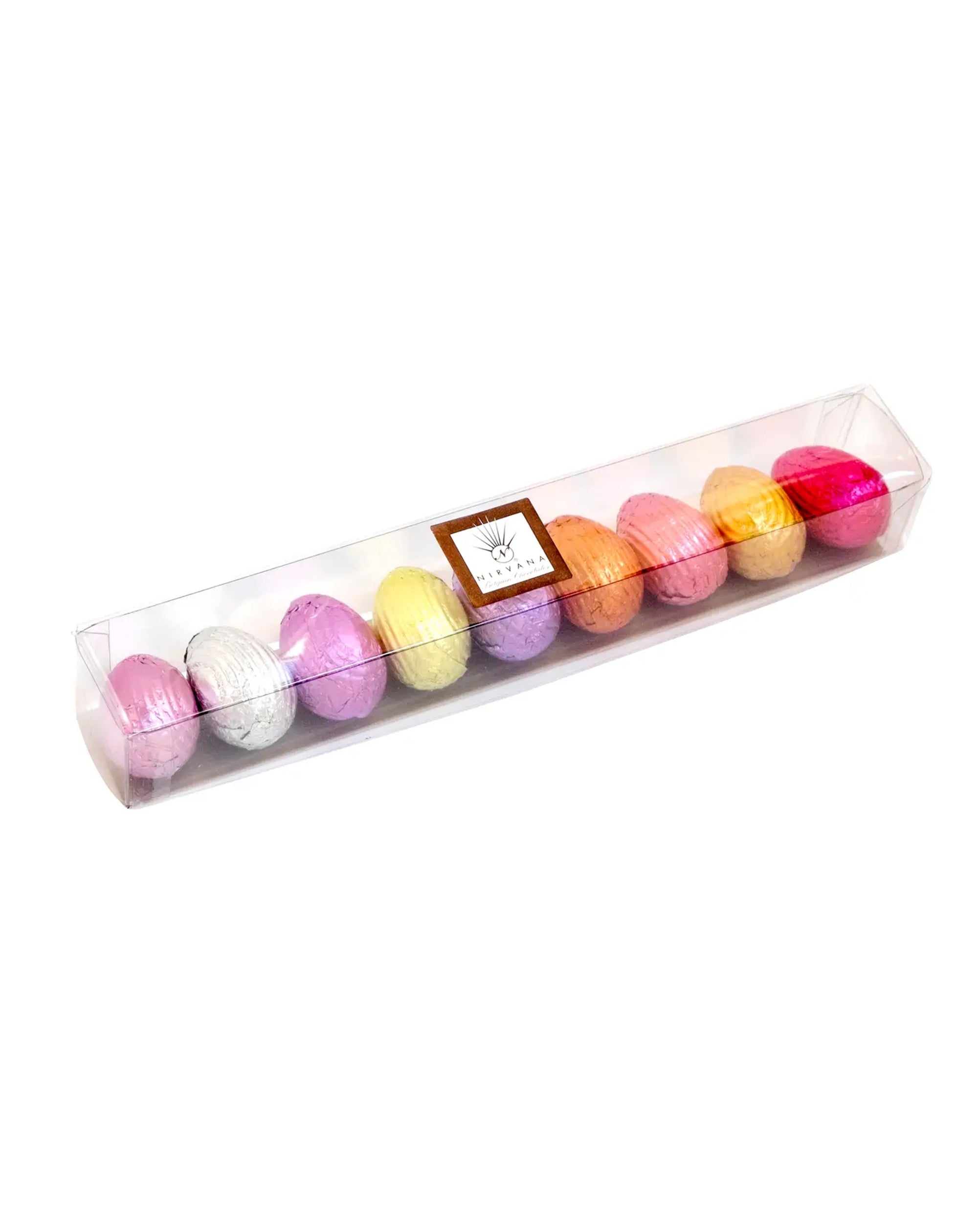 Faire Foil Wrapped Easter Eggs: Ten assorted pastel-colored eggs, foil-wrapped and arranged in a row in a clear rectangular box with a labeled top. Made in Belgium.