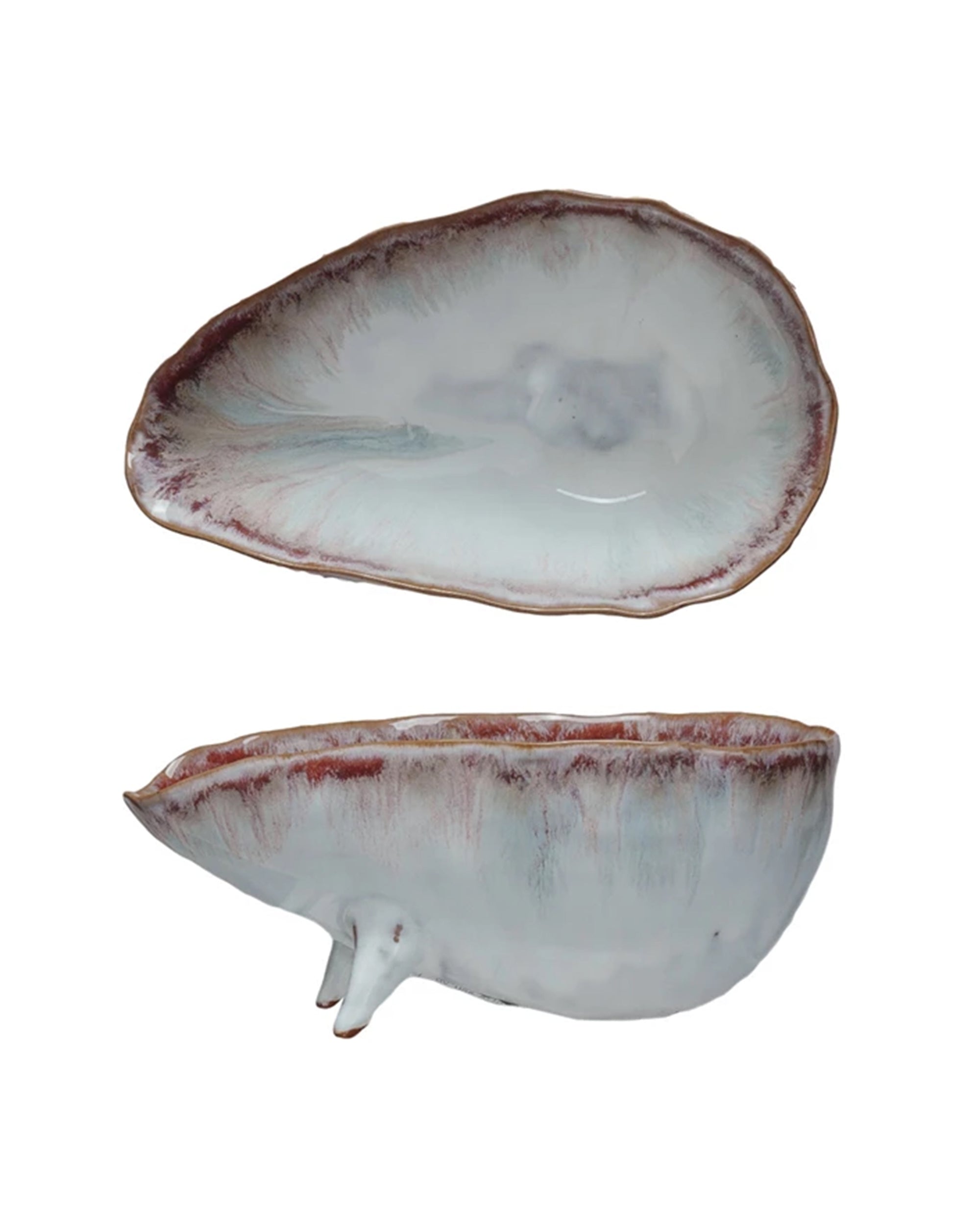Two views of the Bloomingville Stoneware Footed Bowl, shaped like an oyster shell with a white and light purple reactive glaze and textured brown edges, shown from top and side angles.
