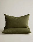 Stacked olive green linen pillowcases by Cultiver Goods USA, shown against a light background.