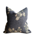 The Faire French Linen Roses Pillow features a dark gray stone-washed cover with a soft, subtle floral pattern in cream and green. This 26x26 pillow offers textured fabric and a relaxed, plush look—perfect for adding floral accents to any room.