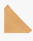 Tan triangle scarf with fringe edge by The Great Inc., Big Sweater Fringe Scarf, displayed on a white background.