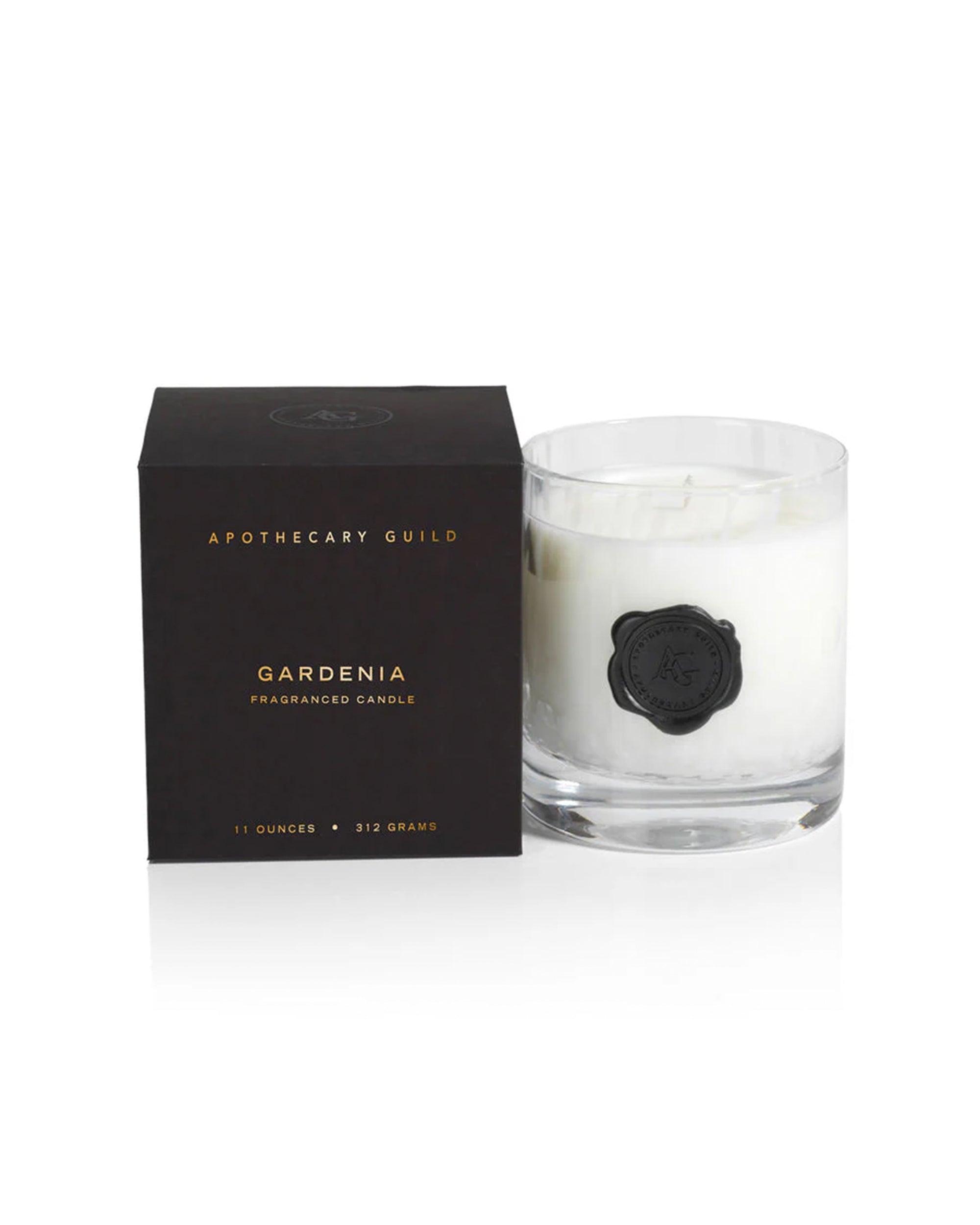 The Zodax IG-2647 Opal Candle, Gardenia scent (11oz), comes in a white jar beside its stylish black box, ideal for those who value elegant, fragrant luxury candles.