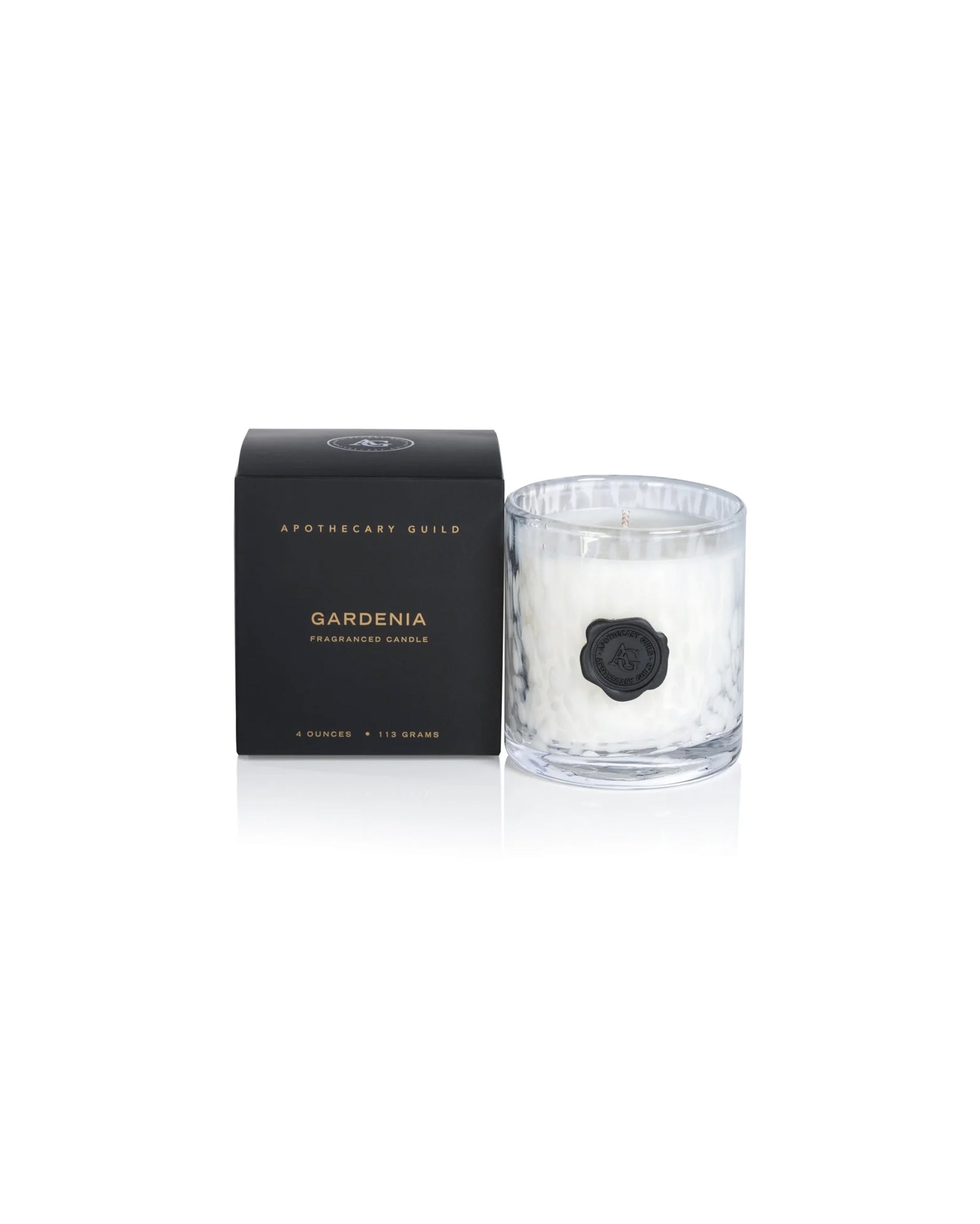 A clear glass IG-2855 Opal Candle Gardenia 4oz by Zodax, with a black wax seal and white wax interior, sits beside a sleek black box—ideal for those who love luxury scented candles.