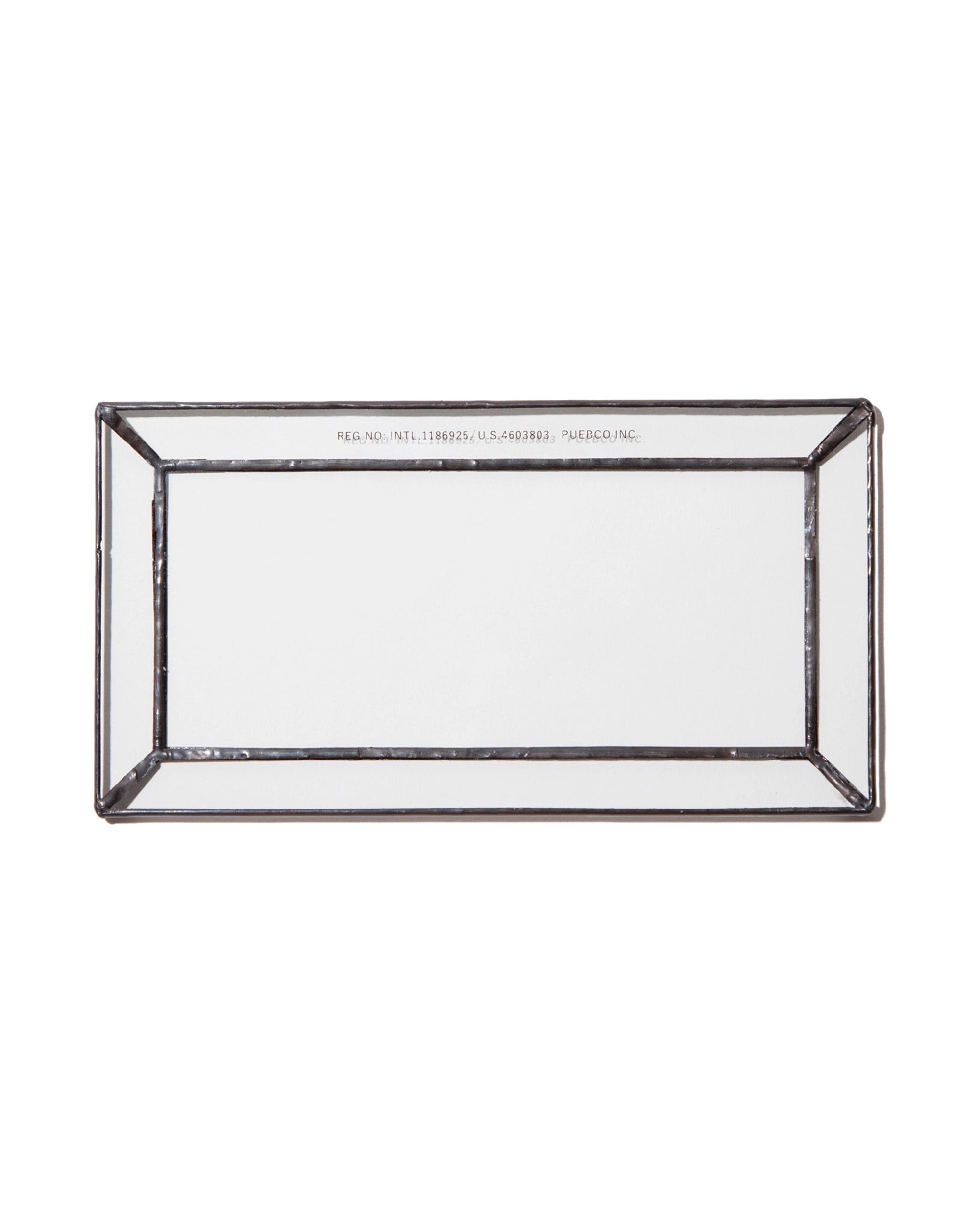 The Faire Glass Valet Tray features a rectangular beveled glass design with a raised edge and silver metal frame, shown from above on a white background.
