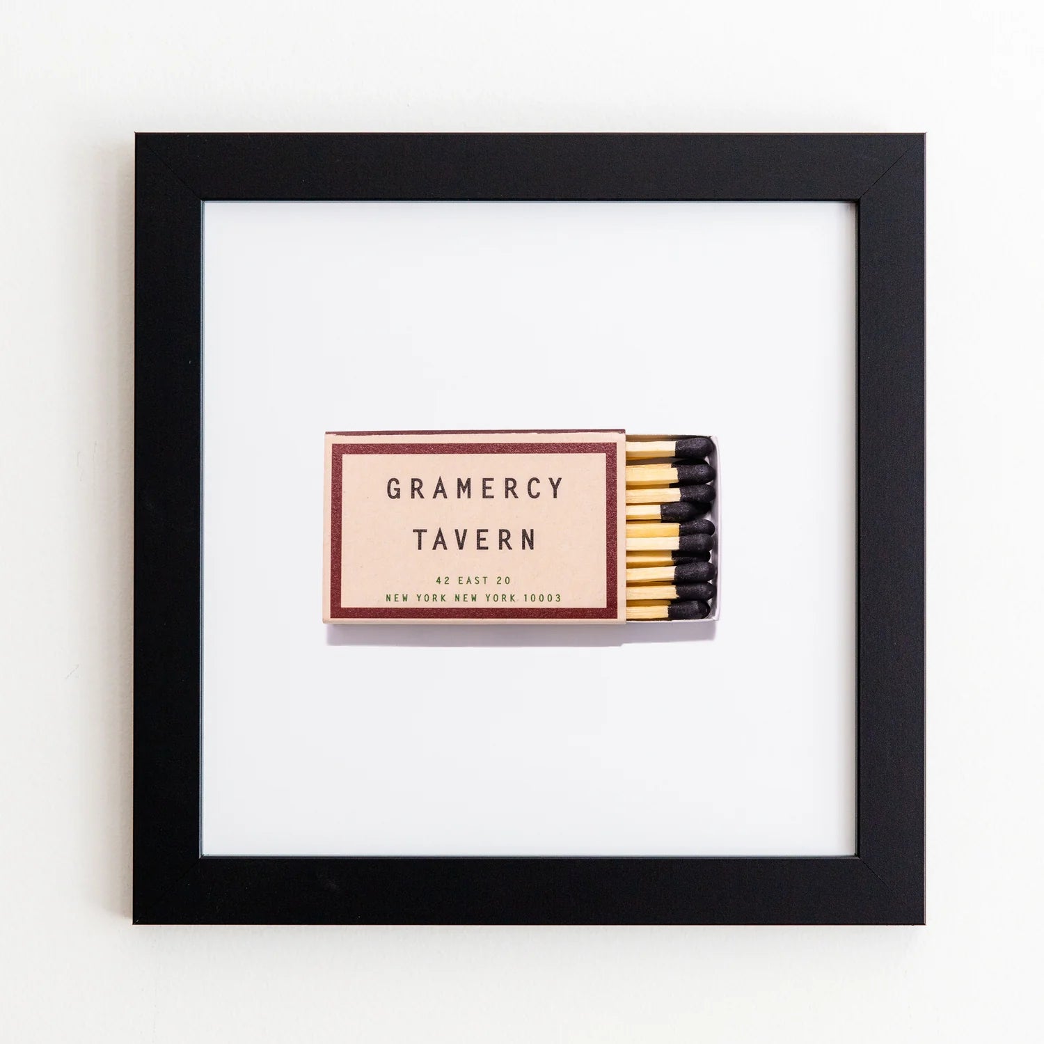 A framed matchbook from Gramercy Tavern in New York City, displayed against a white background. The matchbook features a classic design with the restaurant&#39;s name and address, encased in an Art Square Black Frame by Match South.