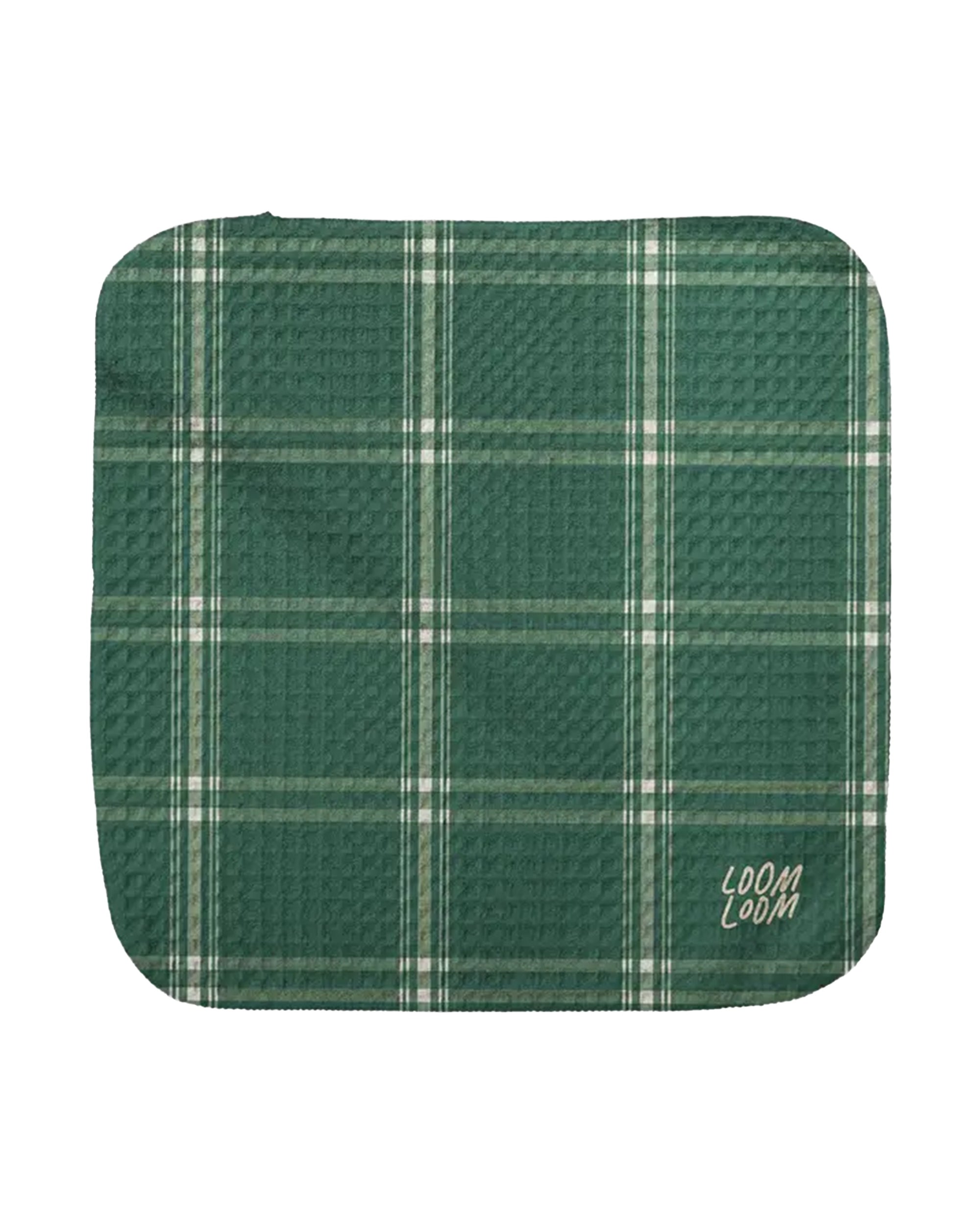 The Faire Green Plaid Dishcloth features a white plaid design and waffle texture on EcoLoom fabric for fast drying, with "LOOM LOOM" printed in white at the bottom right corner.