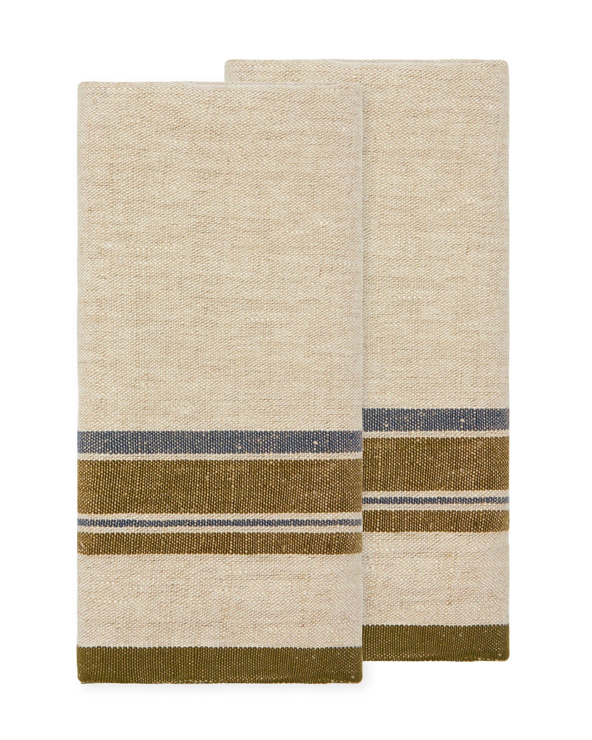 Two folded beige Antibes Natural Towels from Caravan, set of 2, with olive green and dark gray horizontal stripes near the bottom, displayed against a white background.