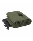 The Faire Olive Green Baja Thunderbird Blanket is handmade in Mexico and features a black bird silhouette, black fringe on one edge, and a classic folded design.