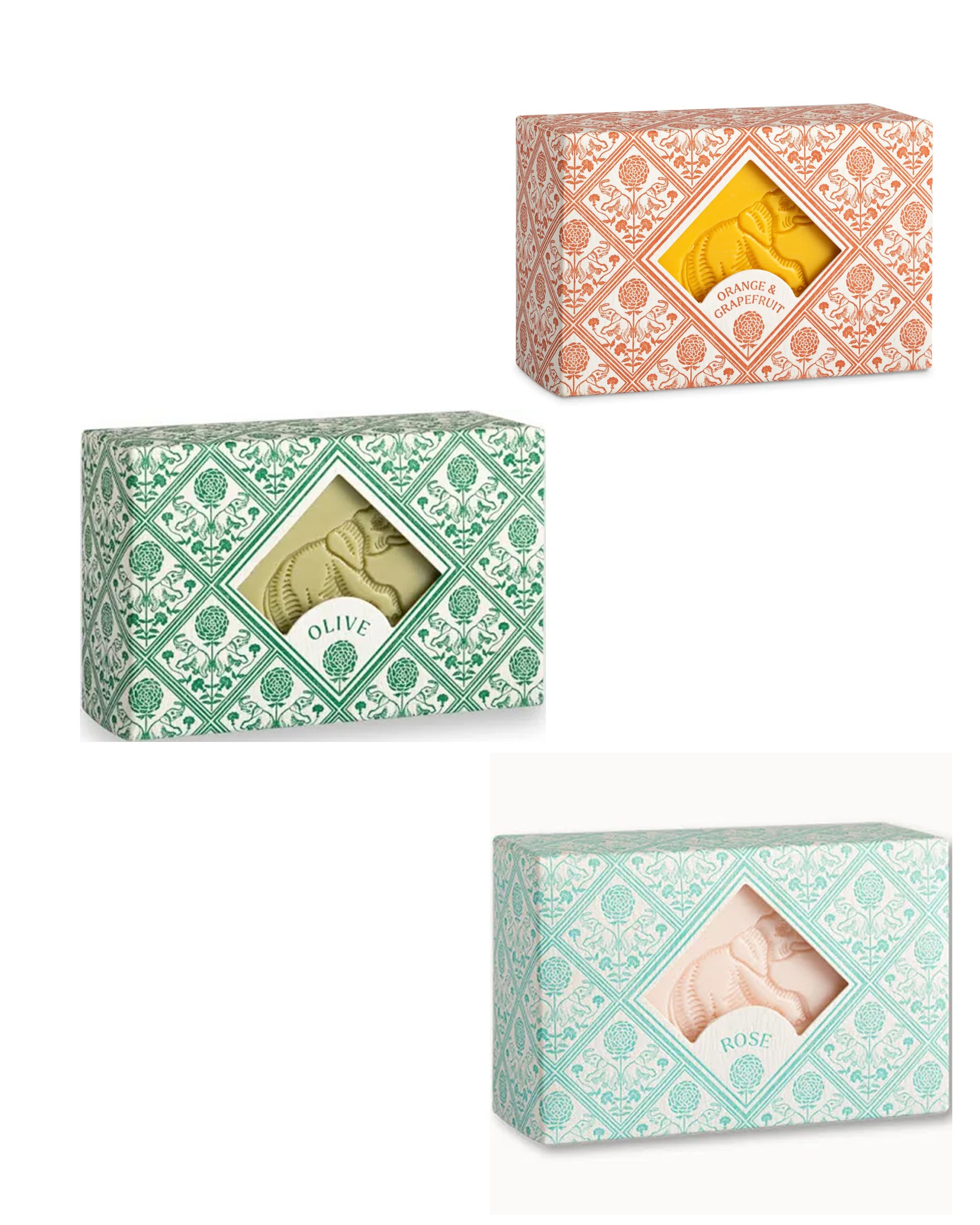 Three Hand and Body Soap Bars by Faire come in patterned orange, green, or pink/green boxes with windows, labeled "Orange & Ginger," "Olive," and "Rose," revealing the artisanal soap inside.