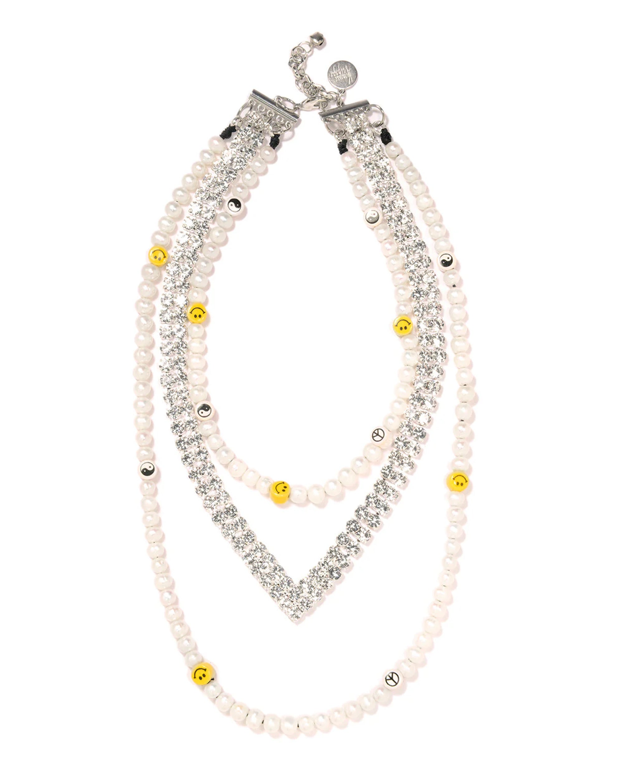 The Venessa Arizaga Happy Dream Necklace 16-26" is a silver-plated double-strand necklace with white freshwater pearls, clear rhinestones, smiley face beads, yellow and metallic accents, and a secure clasp.