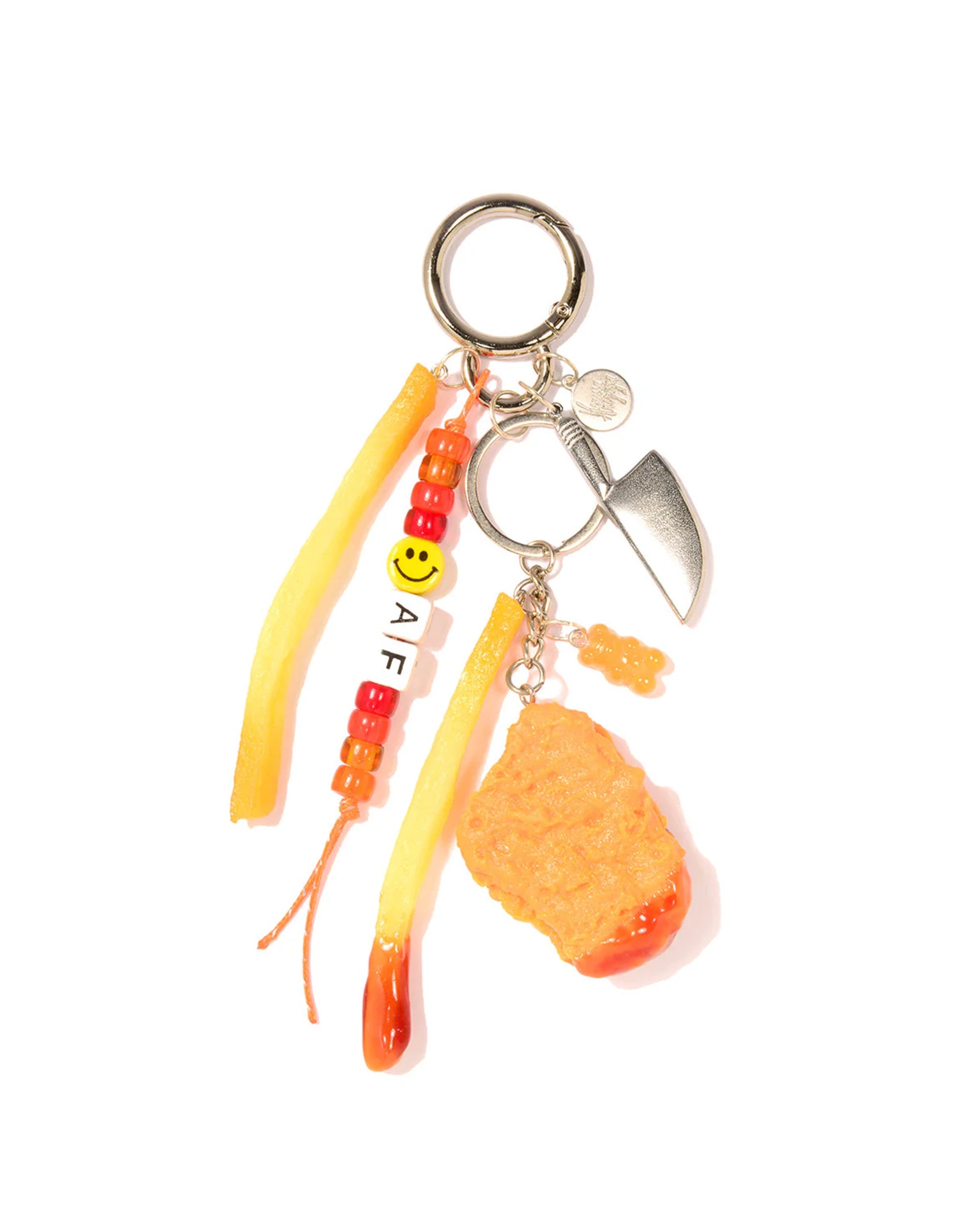 The Venessa Arizaga Bag Key Leash features a silver ring, small knife charm, two French fry and one chicken nugget food charms, orange beads, and a beaded strand with “AF” and a smiley—perfect as a playful bag accessory.