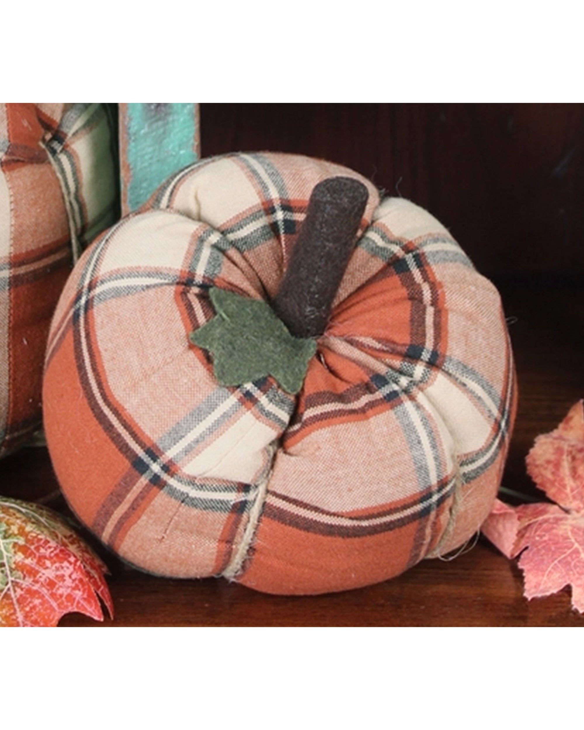 The Faire Pumpkin features orange and cream plaid cloth with a dark brown stem and green leaf—an ideal fall accent or farmhouse decor ornament.