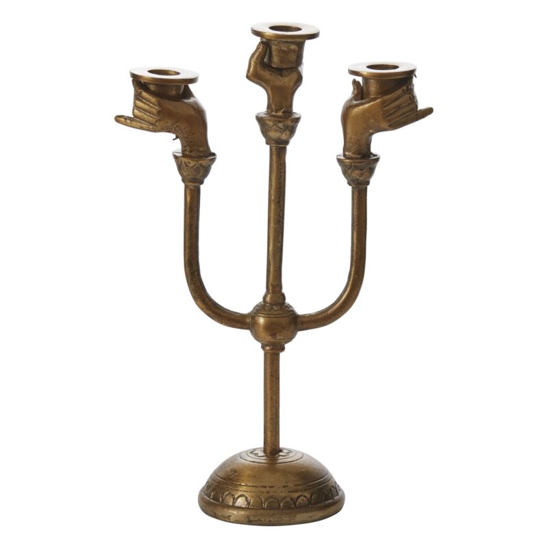 The Accent Decor Haunted Hands Candelabra features three candle holders shaped like gesturing hands on a round base. This antique brass piece adds eerie charm, making it perfect Halloween table decor.