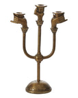 The Accent Decor Haunted Hands Candelabra features three candle holders shaped like gesturing hands on a round base. This antique brass piece adds eerie charm, making it perfect Halloween table decor.
