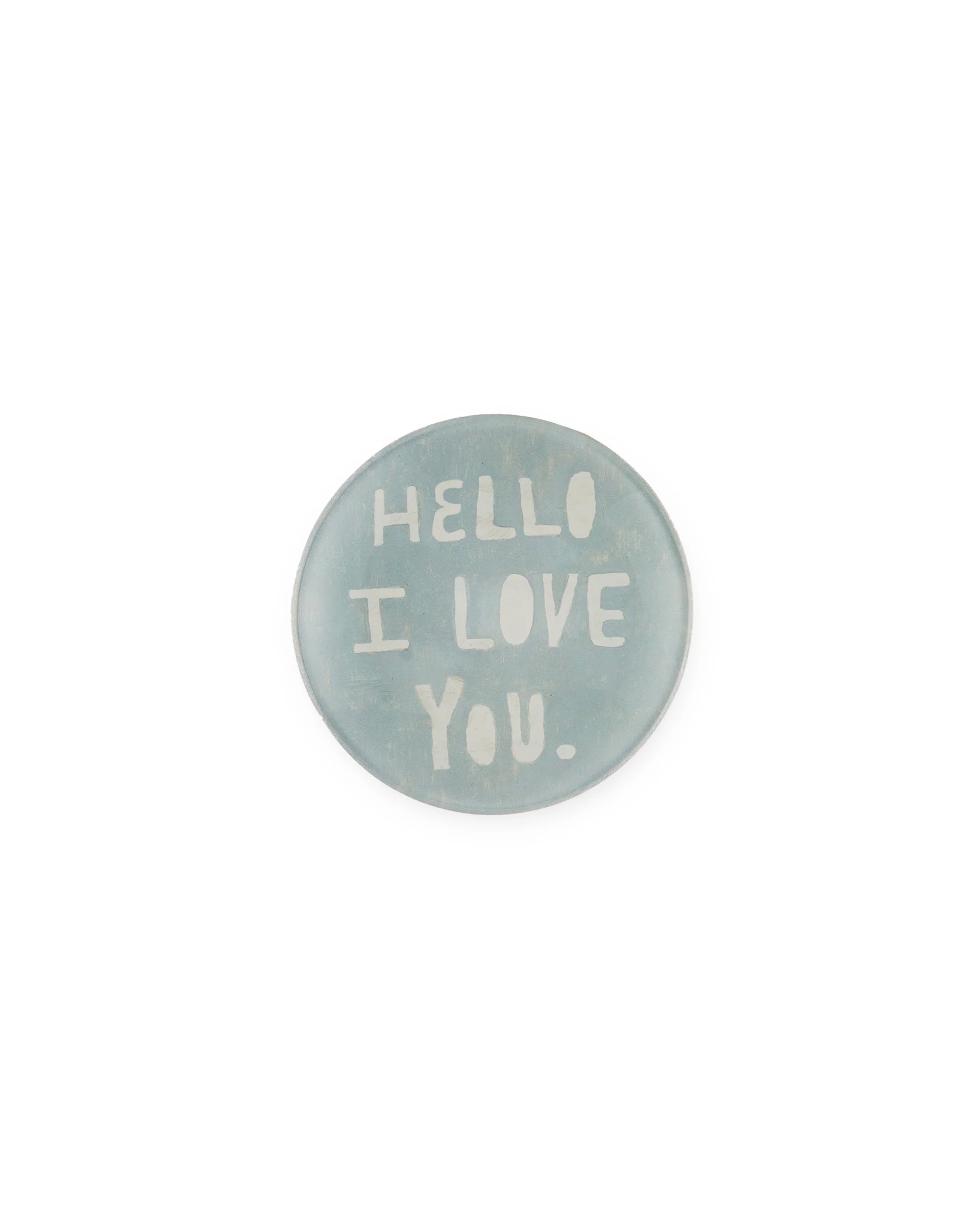 The Hello I Love You Round Plate by Sugarboo Designs features light blue with white, uppercase, hand-drawn text. Centered on a plain background, this charming plate makes a sweet and thoughtful gift.