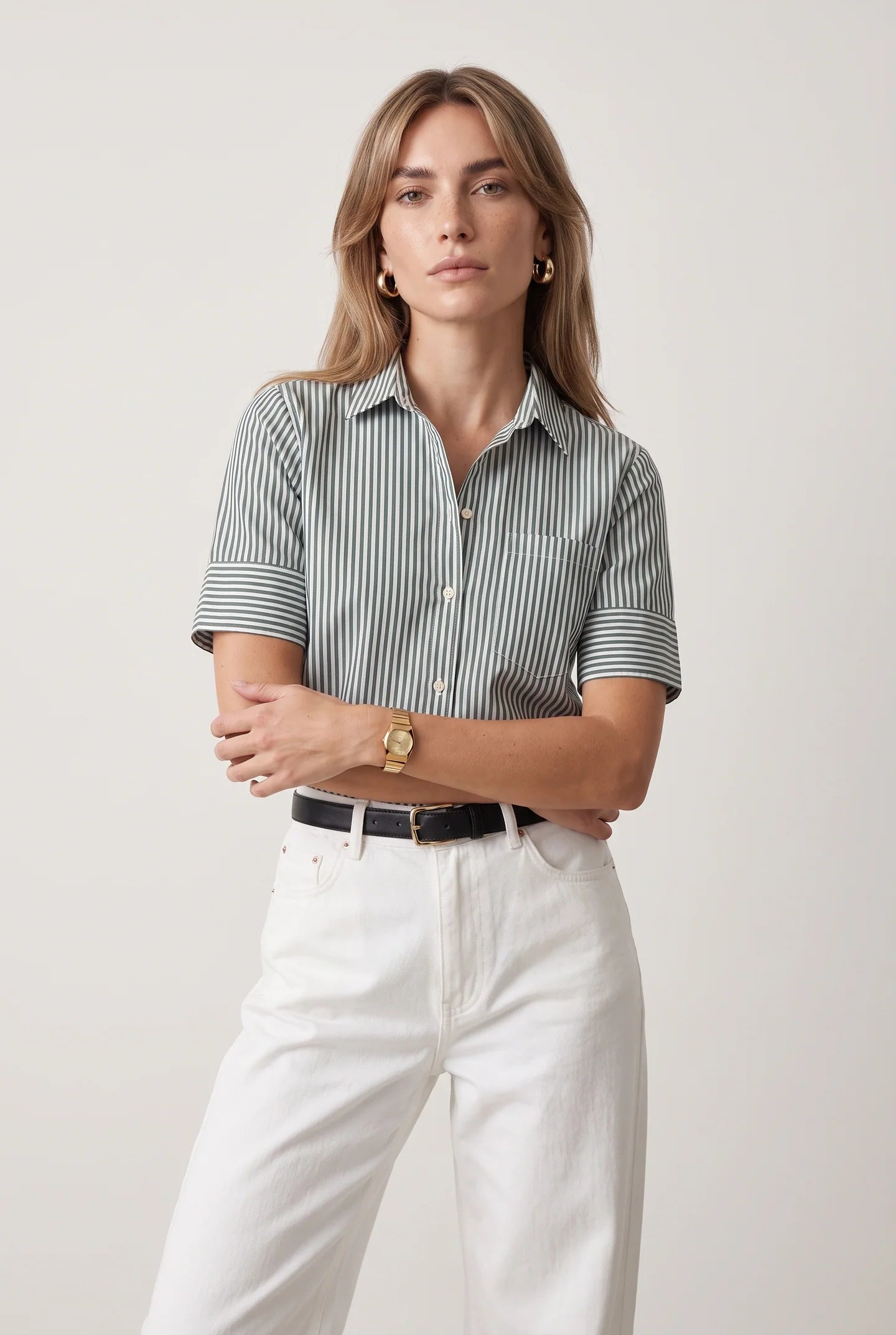 THE SHIRT short sleeve shirt in white, styled with matching pants, model stands confidently facing forward.