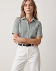 THE SHIRT short sleeve shirt in white, styled with matching pants, model stands confidently facing forward.