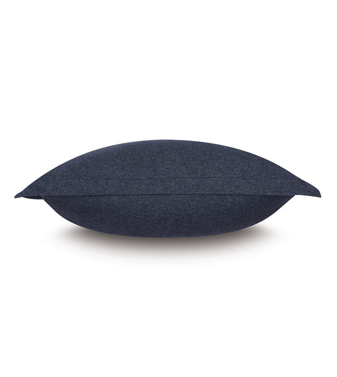 The HIGGINS DENIM pillow by Eastern Accents, featuring a dark blue rectangular design with smooth fabric, is displayed horizontally on a white background in a side view.
