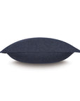 The HIGGINS DENIM pillow by Eastern Accents, featuring a dark blue rectangular design with smooth fabric, is displayed horizontally on a white background in a side view.