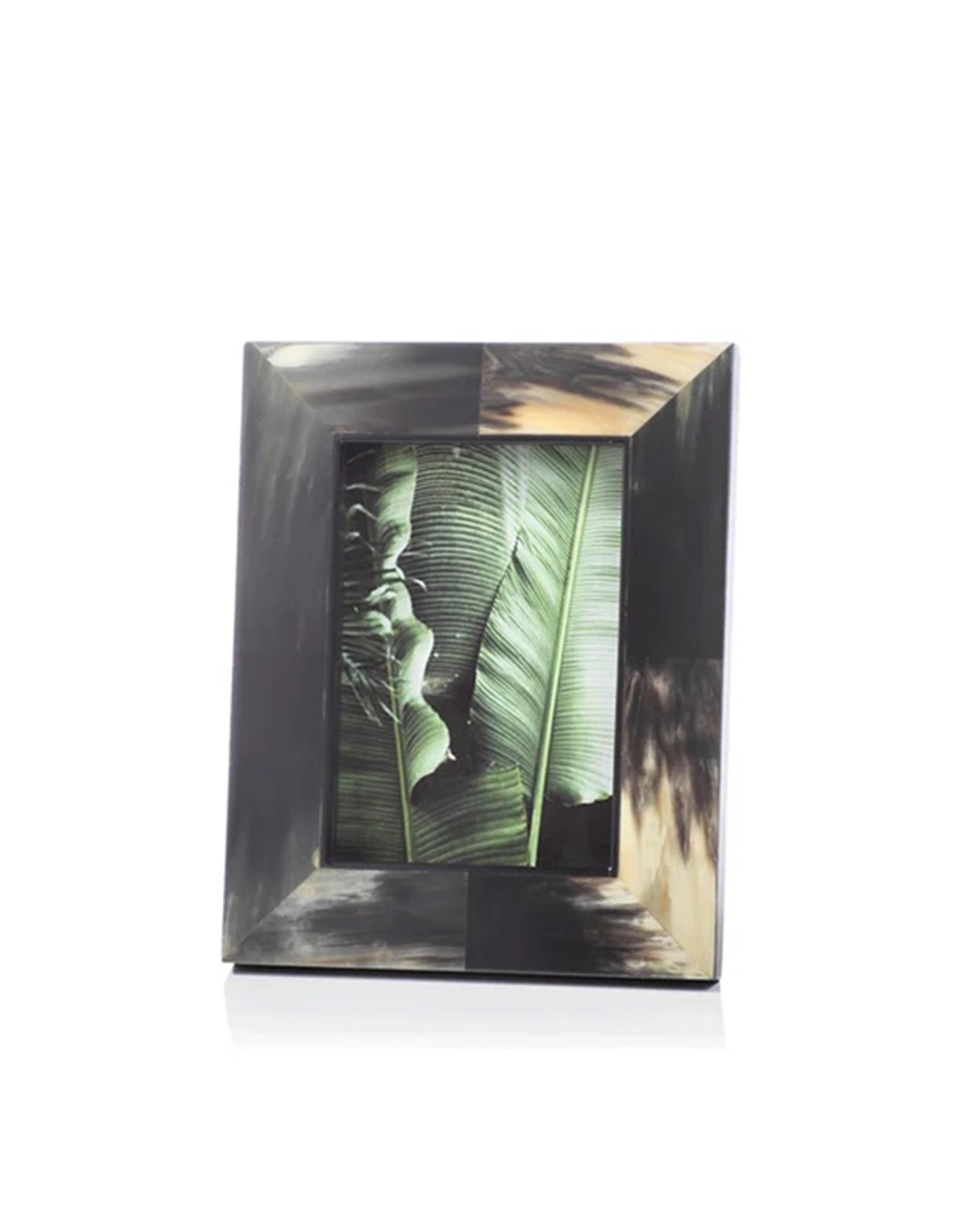 The Zodax IN-6408 Horn Photo Frame 5x7 features a rectangular, elegant design with a glossy dark and light marbled pattern, displaying a photo of large green tropical leaves on a plain white background.